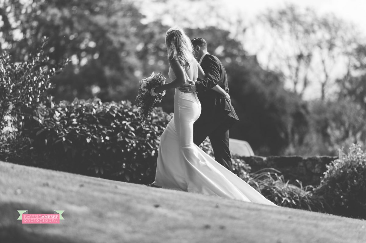 bride and groom wedding walking arm in arm black and white portrait