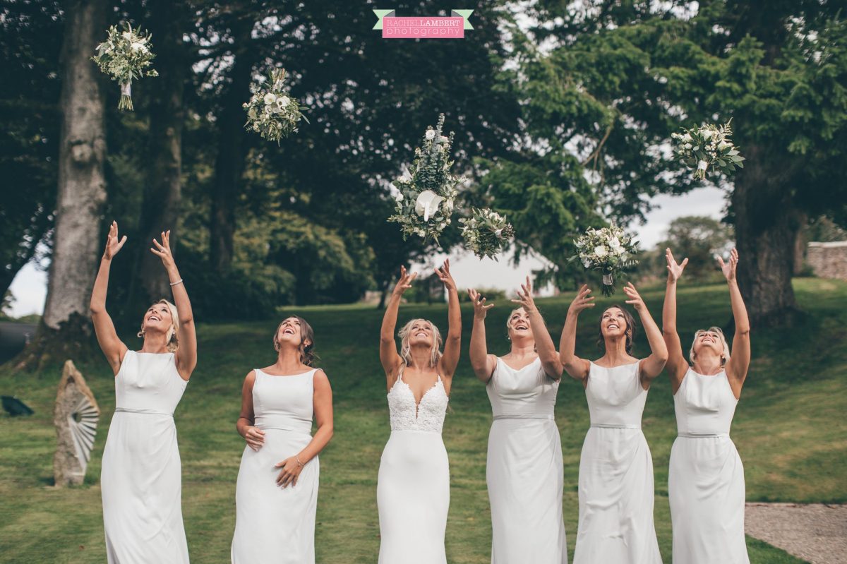 bride and bridesmaids throwing bouquets the grove nartberth