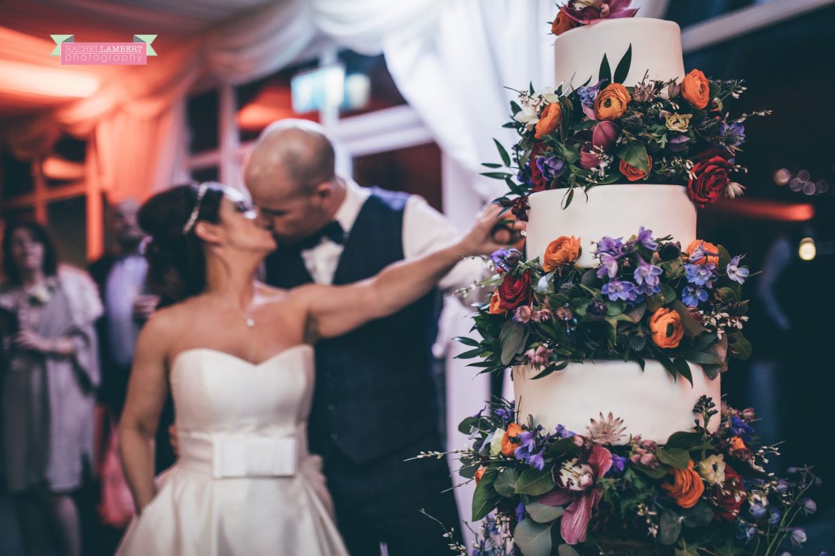 bride and groom cutting the cake