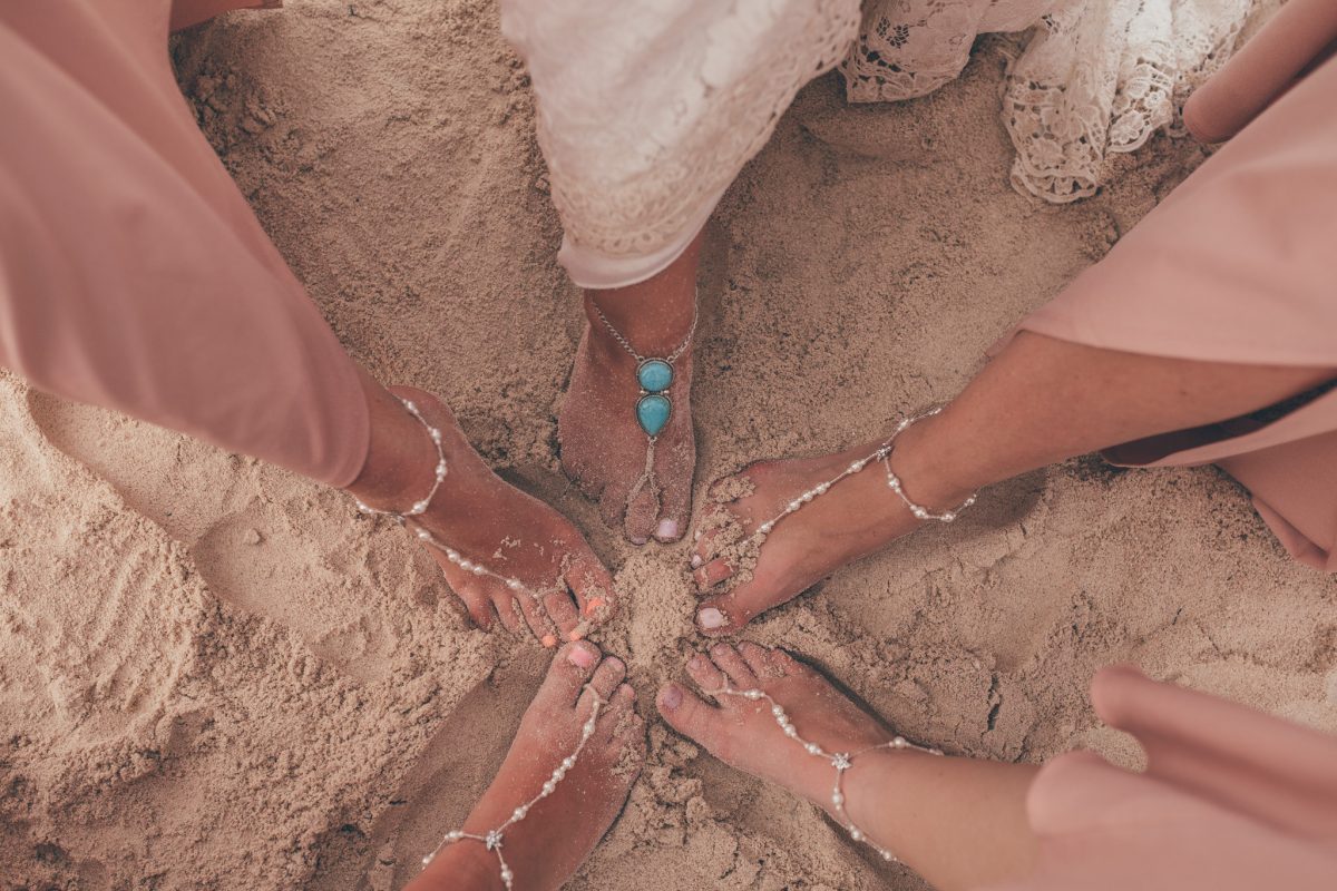 bride and bridesmaids feet in the sand in jamaica destination wedding photography rachel lambert photography