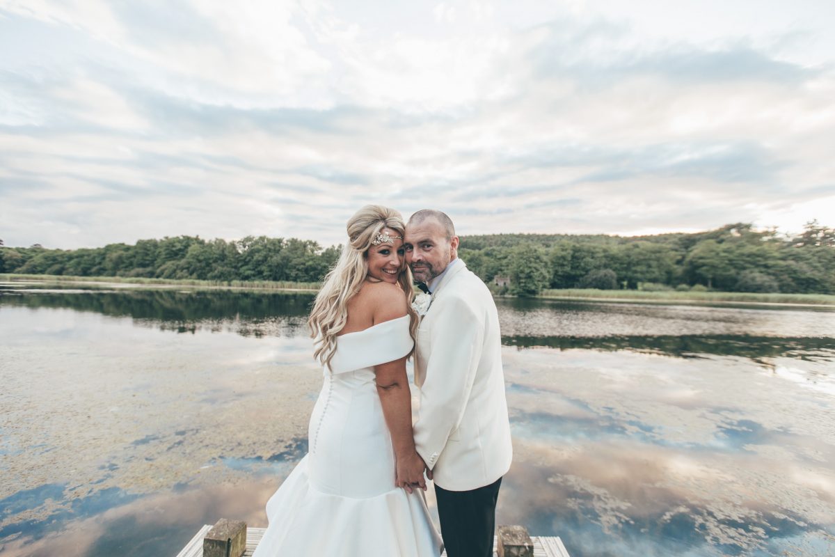 bride and groom by the lake at hensol castle wales rachel lambert photography