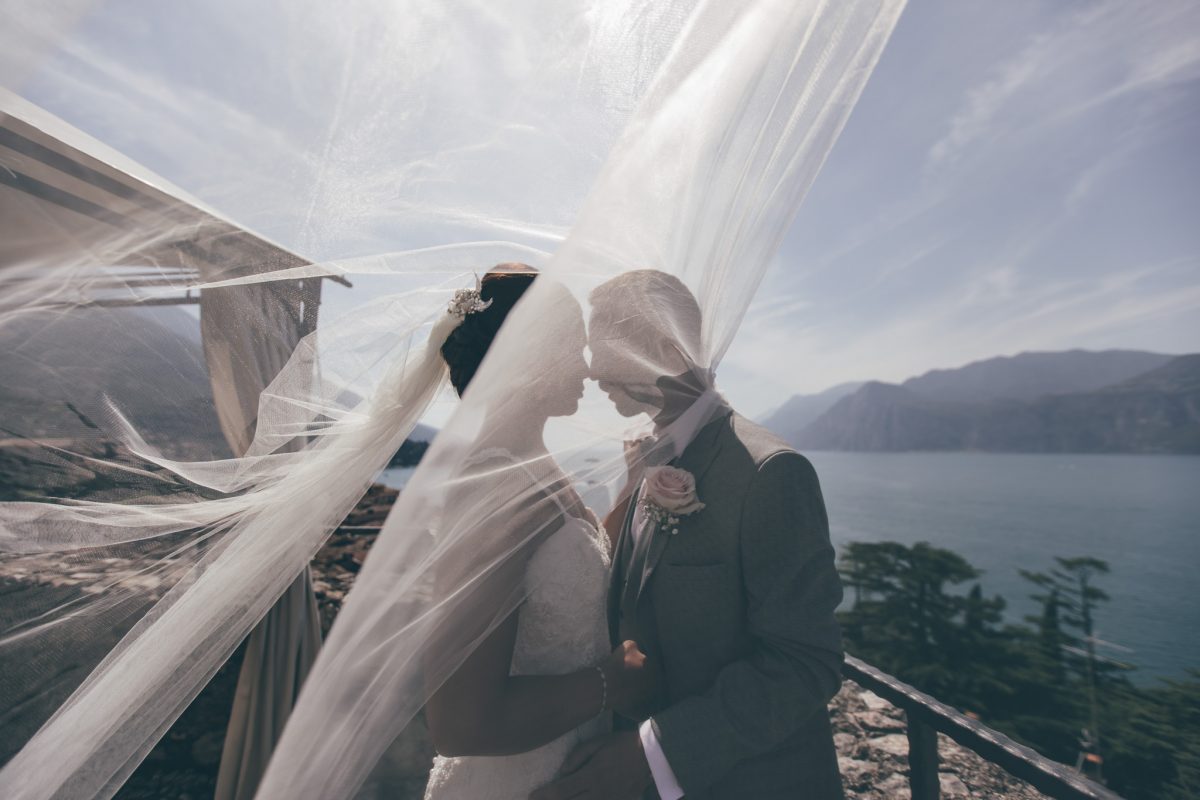 bride and groom at malcesine castle with veil rachel lambert photography