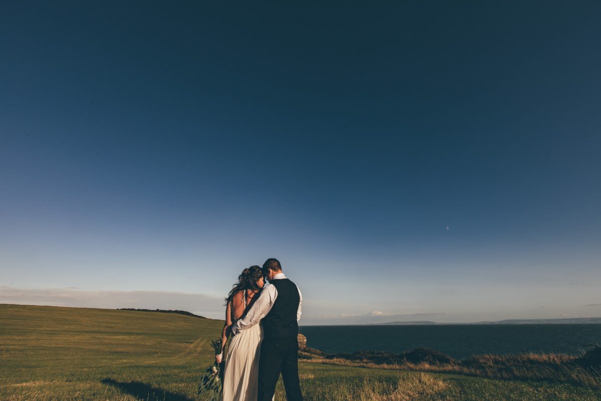 bride and groom cliff top at rosedew farm summer wedding rachel lambert photography