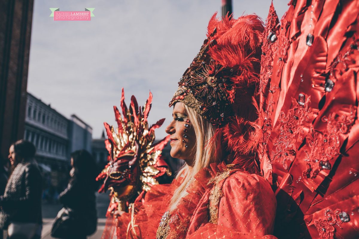 venice mask festival st marks square italy red feathers