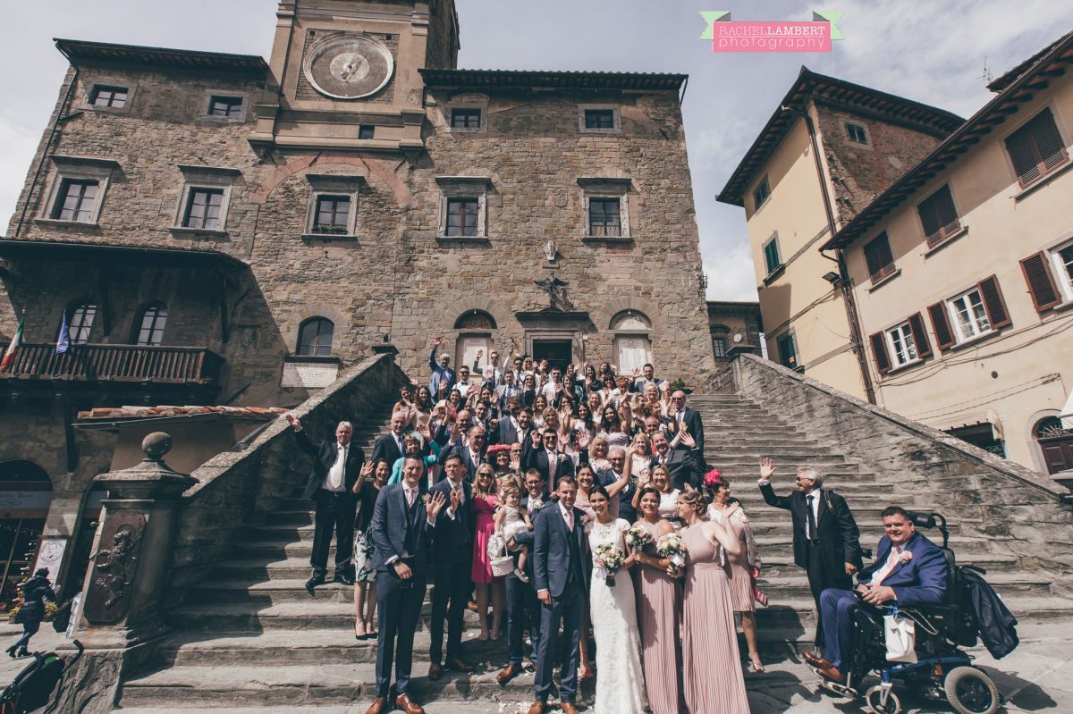 bride and groom portrait wedding in italy colour cortona tuscany group shot on steps at town hall