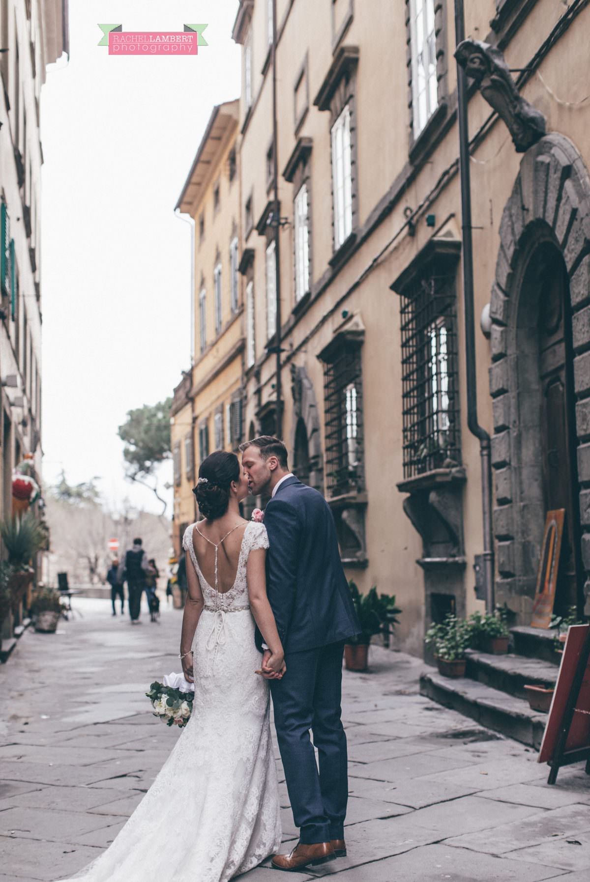 bride and groom portrait wedding in italy colour cortona tuscany walking through street