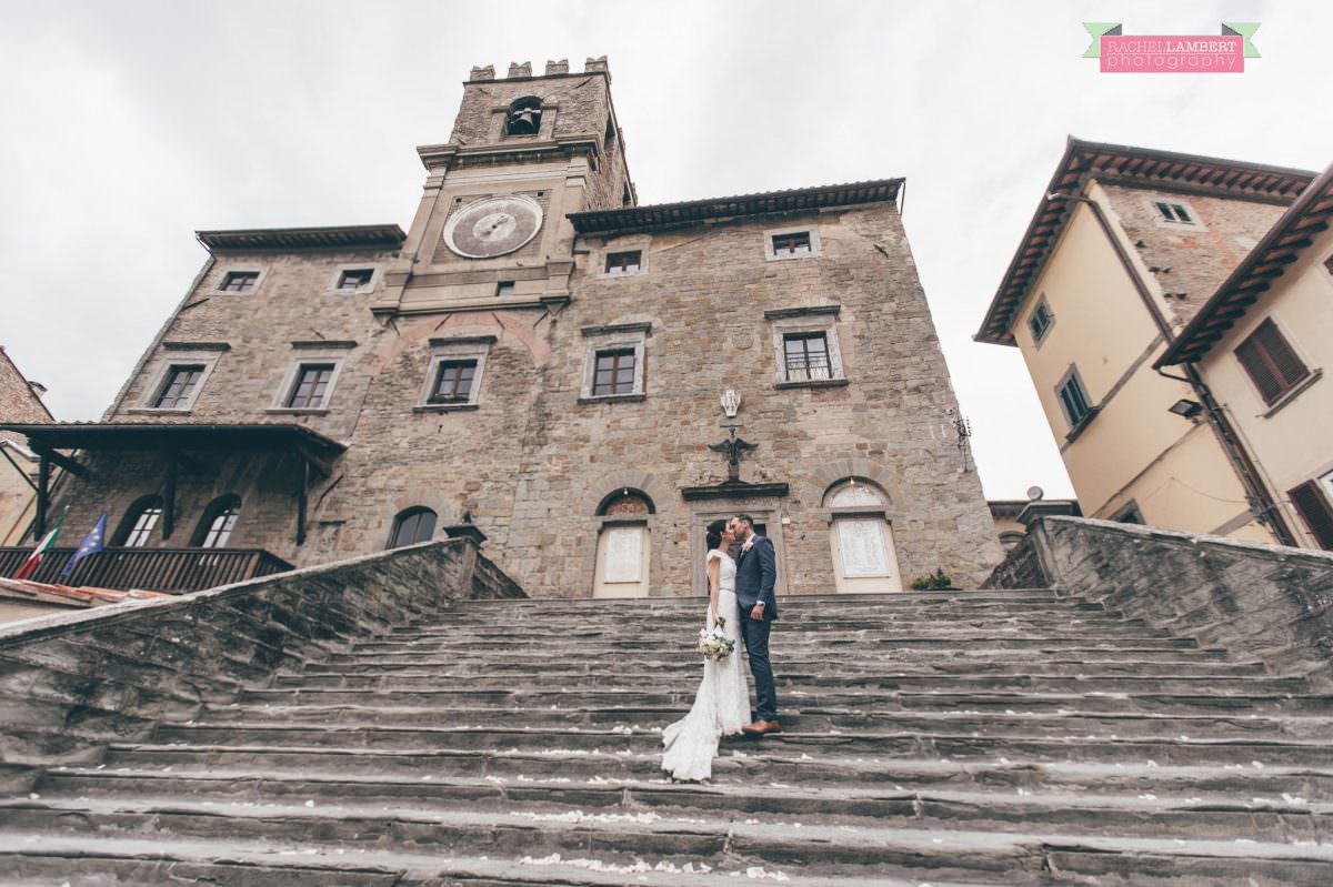 bride and groom portrait wedding in italy colour cortona tuscany town hall steps