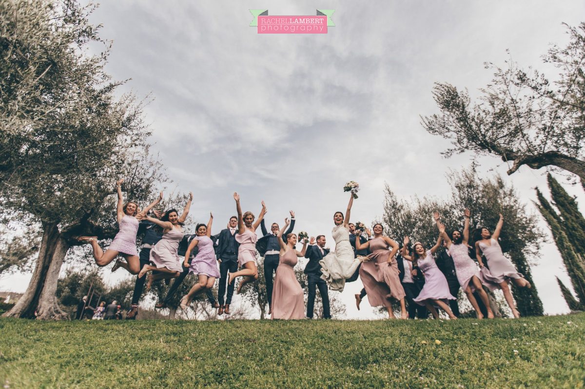 bride and groom bridal party group shots wedding in italy jumping