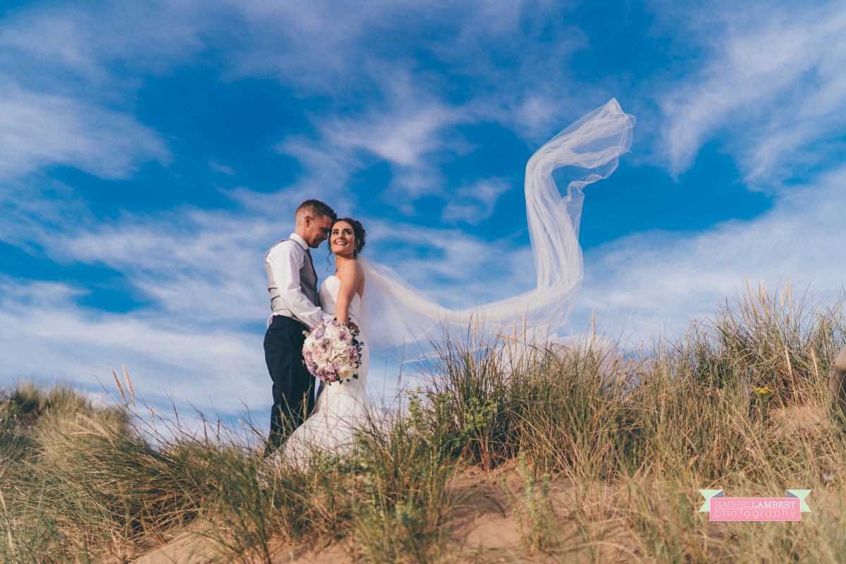 olwalls wedding photographer rachel lambert photography bride and groom llangennith beach golden hour long veil shot