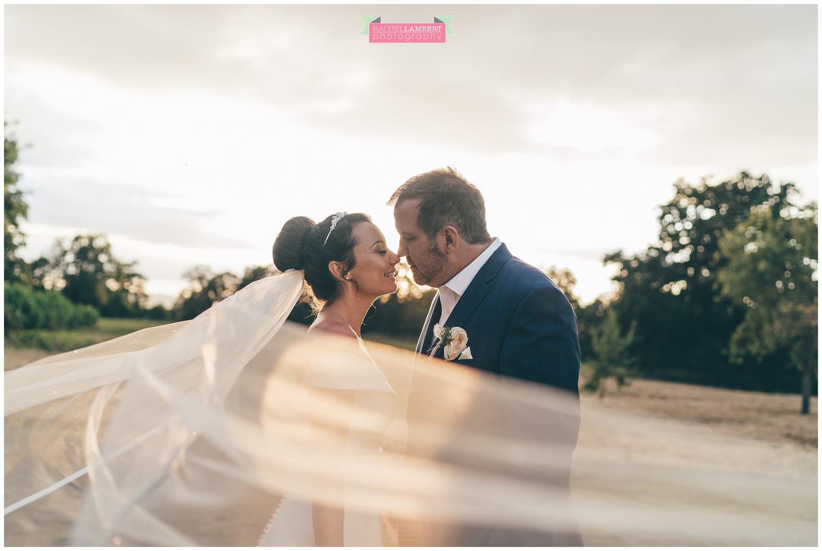 elmore court wedding photographer veil shot bride and groom golden hour