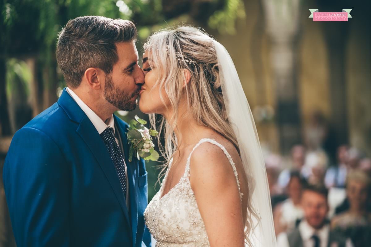 wedding photographer sorrento italy bride and groom chiostro di san francesco laura may bridal first kiss