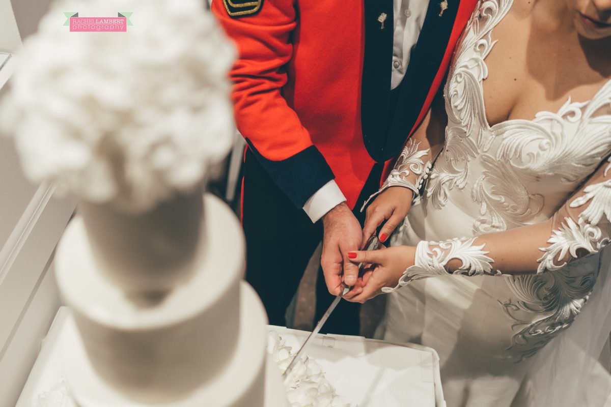 welsh wedding photographer at hensol castle cutting the cake